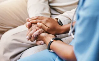 Older couple holding each others hands