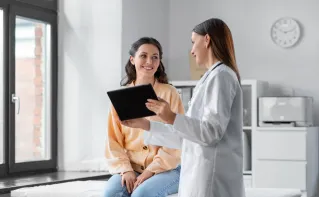 Patient sitting speaking with doctor