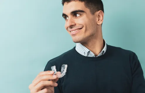 Person holding a bite guard